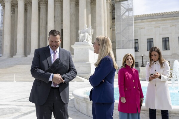 FILE - Kansas Attorney General Kris Kobach, left, and Erin Hawley, Alliance Defending Freedom Senior Counsel, speak to each other outside the Supreme Court after the Court heard oral arguments, Tuesday, March 26, 2024, in Washington. Kansas’ highest court on Friday, July 5, 2024, struck down state laws regulating abortion providers more strictly than other health care providers and banning a common second-trimester procedure, reaffirming its stance that the state constitution protects abortion access. (AP Photo/Amanda Andrade-Rhoades, File)