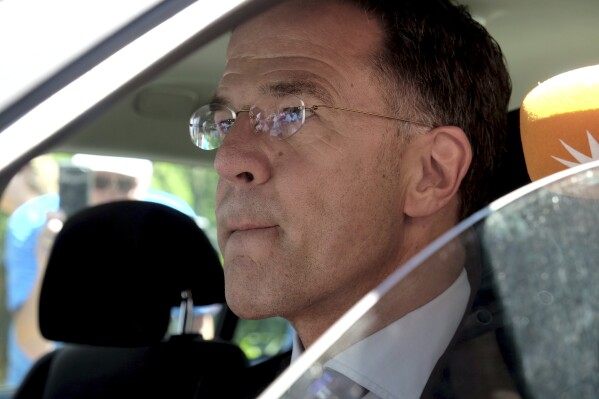 Dutch Prime Minister Mark Rutte sits in a car as he leaves Palace Huis ten Bosch in The Hague, Netherlands, Saturday, July 8, 2023 after he informed King Willem-Alexander that his coalition government has resigned. Rutte announced the collapse of the government Friday night and declined to answer reporters' questions as he left. (AP Photo/Michael Corder)