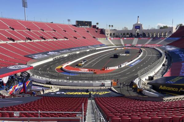 A temporary auto racing track is shown inside the Coliseum ahead of a NASCAR exhibition race in Los Angeles, Friday, Feb. 4, 2022. NASCAR is hitting Los Angeles a week ahead of the Super Bowl, grabbing the spotlight with its wildest idea yet: The Clash, the unofficial season-opening, stock-car version of the Pro Bowl, will run at the iconic Coliseum in a made-for-Fox Sports spectacular. (AP Photo/Jenna Fryer)