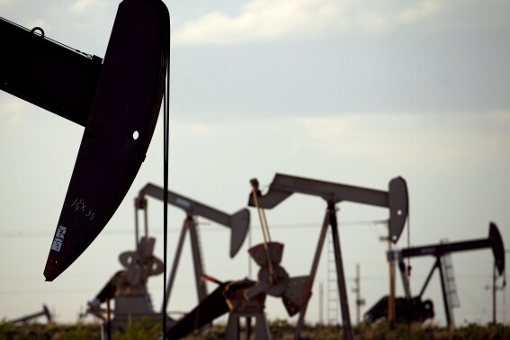 FILE - Pump jacks work in a field near Lovington, N.M., April 24, 2015. (AP Photo/Charlie Riedel, File)