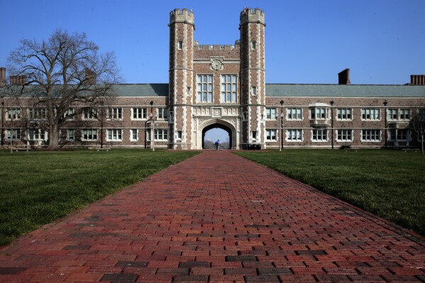 FILE - A police officer rolls past Brookings Hall on the campus of Washington University, Wednesday, March 11, 2020, in St. Louis, Mo. The Association of Black Students at St. Louis' Washington University on Friday, April 5, 2024, held a sit-in at a dining hall where a group of students last month allegedly threw eggs, stood on tables and said racial slurs in front of primarily racial minority workers. (Robert Cohen/St. Louis Post-Dispatch via AP, File)