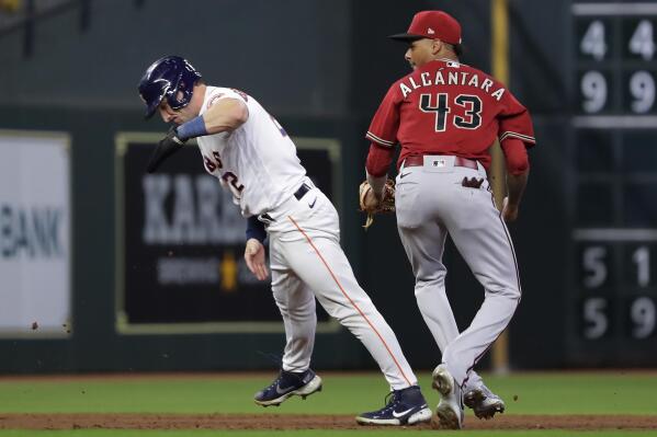Houston Astros' Alex Bregman (2) is tagged out between second and third base by Arizona Diamondbacks third baseman Sergio Alcantara (43) during the seventh inning of a baseball game Wednesday, Sept. 28, 2022, in Houston. (AP Photo/Michael Wyke)