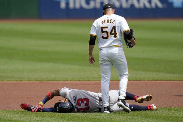 Pittsburgh Pirates starting pitcher Martín Pérez (54) checks on Atlanta Braves' Ronald Acuña Jr. who injured himself running the bases during the first inning of a baseball game against the Pittsburgh Pirates in Pittsburgh, Sunday, May 26, 2024. Acuna Jr. left the game. (AP Photo/Gene J. Puskar)