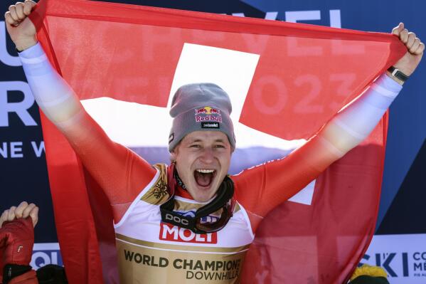 Switzerland's Marco Odermatt celebrates winning the alpine ski, men's World Championship downhill, in Courchevel, France, Sunday, Feb. 12, 2023. (AP Photo/Marco Trovati)