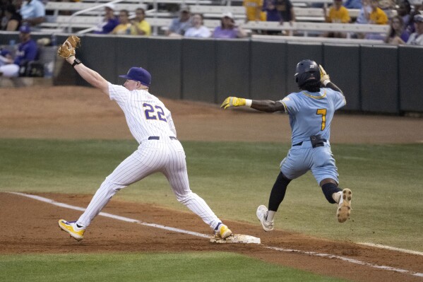 LSU first baseman Jared Jones (22) makes the catch at first base in time to put out Southern's Khyle Radcliffe (7) during an NCAA college baseball game, Monday, April 1, 2024, in Baton Rouge, La. Southern University recorded the biggest upset of the college baseball season with its 12-7 victory over defending national champion LSU on Monday night. (Hilary Scheinuk/The Advocate via AP)