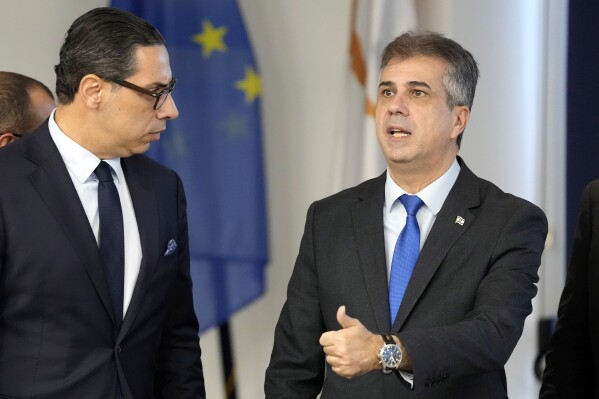 Israeli Foreign Minister Eli Cohen, right, gestures, after a meeting with his Cypriot counterpart Constantinos Kombos, left, at the Zenon Joint Rescue Coordination Center in southern coastal city of Larnaca, Cyprus Wednesday, Dec. 20, 2023. Kombos is briefing Cohen on a Cyprus government initiative to continuously ship large quantities of humanitarian aid to Gaza from Larnaca port some 240 miles away from the enclave. (AP Photo/Petros Karadjias)