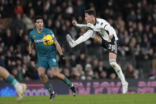 Fulham's Sasa Lukic, right, controls the ball during the English Premier League soccer match between Fulham and Wolverhampton Wanderers at Craven Cottage stadium in London, Friday, Feb. 24, 2023. (AP Photo/Kirsty Wigglesworth)