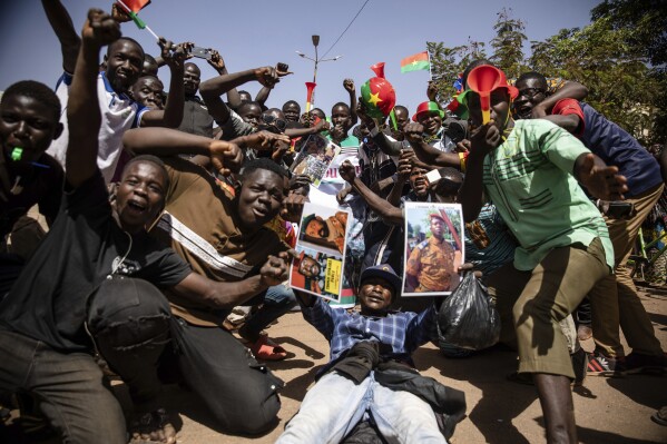 FILE - People take to the streets of Ouagadougou, Burkina Faso, on Jan. 25, 2022 to rally in support of the new military junta that ousted democratically elected President Roch Marc Christian Kabore and seized control of the country. The military juntas ruling Mali, Burkina Faso and Niger say they have agreed to create a joint force to fight extremist violence in their nations. No details of how the force will operate have been released, even though the countries are experiencing financial difficulties with overstretched militaries. (AP Photo/Sophie Garcia, File)