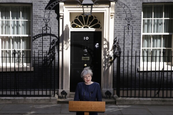 FILE - Britain's Prime Minister Theresa May speaks to the media outside her official residence of 10 Downing Street in London, Tuesday April 18, 2017. Theresa May, who succeeded David Cameron after he resigned following Britain's vote to leave the European Union in a referendum in June 2016, sought to capitalize on the Conservative Party's big opinion poll lead and called an early general election for June 2017. (AP Photo/Alastair Grant, File)