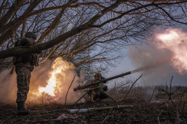 Ukrainian servicemen of 68 OleksaDovbush hunting brigade fire a rocket by SPG-9 towards Russian positions at the frontline near Vuhledar, Ukraine, Wednesday, Feb. 22, 2023. (AP Photo/Evgeniy Maloletka)