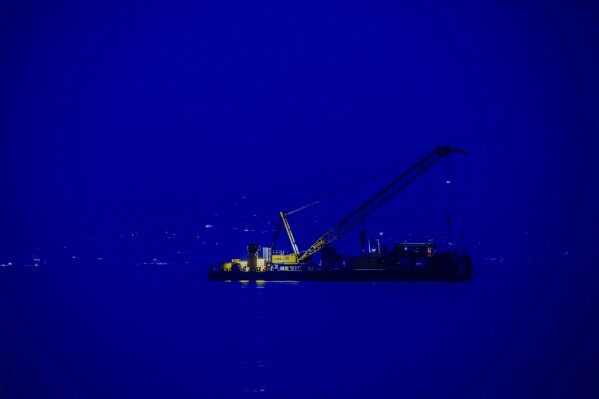 FILE -The multi-purpose floating work barge Hebo Lift 2 monitors the stretch of sea off Porticello, near Palermo, Sicily, Italy, May 4, 2025, where the British superyacht Bayesian sunk on August 19, 2024 as the operations for its recovery start. (AP Photo/Salvatore Cavalli), File)
