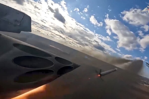In this photo taken from a video released by the Russian Defense Ministry Press Service on Saturday, Jan. 6, 2024, Su-25 ground attack jets fire rockets during a Russian air force mission in Ukraine. (Russian Defense Ministry Press Service via AP)