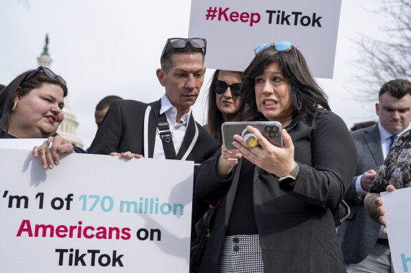 Devotees of TikTok monitor voting at the Capitol in Washington, as the House passed a bill that would lead to a nationwide ban of the popular video app if its China-based owner doesn't sell, Wednesday, March 13, 2024. Lawmakers contend the app's owner, ByteDance, is beholden to the Chinese government, which could demand access to the data of TikTok's consumers in the U.S. (AP Photo/J. Scott Applewhite)