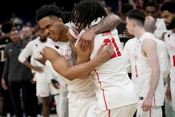 Houston guard Ramon Walker Jr., left, and Houston guard Emanuel Sharp (21) celebrate the team's win after a second-round college basketball game against Texas A&M in the NCAA Tournament, Sunday, March 24, 2024, in Memphis, Tenn. Houston won 100-95 in overtime. (AP Photo/George Walker IV)