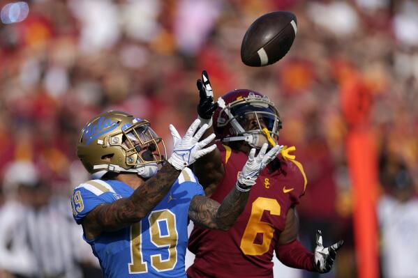 UCLA running back Kazmeir Allen, left, makes a touchdown catch as Southern California cornerback Isaac Taylor-Stuart defends during the first half of an NCAA college football game Saturday, Nov. 20, 2021, in Los Angeles. (AP Photo/Mark J. Terrill)