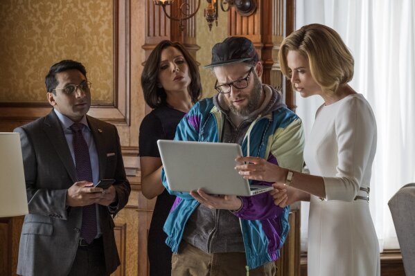 
              This image released by Lionsgate shows Ravi Patel, from left, June Diane Raphael, Seth Rogen and Charlize Theron in a scene from "Long Shot." (Philippe Bossé/Lionsgate via AP)
            