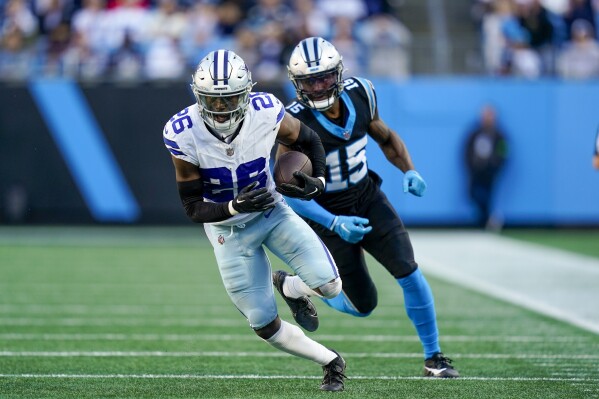 Dallas Cowboys cornerback DaRon Bland intercepts a pass intended for Carolina Panthers wide receiver Jonathan Mingo during the second half of an NFL football game Sunday, Nov. 19, 2023, in Charlotte, N.C. Bland scored n the play. (AP Photo/Erik Verduzco)