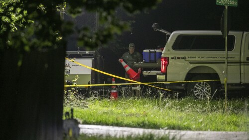 Members of several law enforcement agencies investigate the scene were several people were reportedly killed after a hostage situation on Thursday, July 20, 2023, in Verdigris, Okla. (Daniel Shular/Tulsa World via AP)