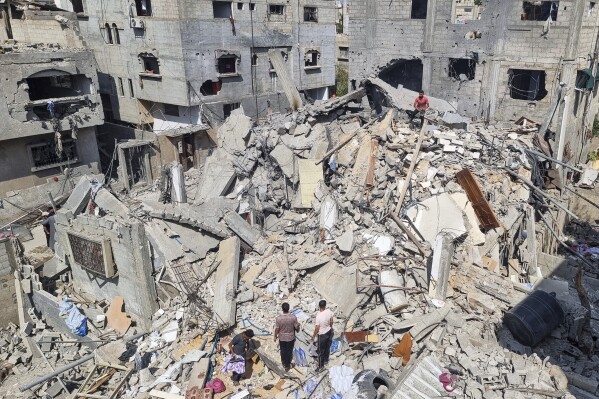 Palestinians look at the destruction after an Israeli airstrike in Rafah, Gaza Strip. Monday, April 29, 2024. (AP Photo/Mohammad Jahjouh)