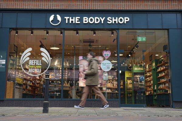 People walk past a Body Shop store in Canterbury, England, Tuesday, Feb. 13, 2024. The Body Shop, the British beauty and cosmetics retail chain, says it's appointed insolvency administrators after years of financial struggles. The retailer grew from a single shop in 1976 to become one of the most recognizable retailers on the British high street with hundreds of stores in the United Kingdom and beyond. (Gareth Fuller/PA via AP)