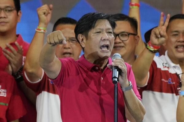 FILE - Presidential hopeful, former senator Ferdinand "Bongbong" Marcos Jr., the son of the late dictator, gestures as he greets the crowd during a campaign rally in Quezon City, Philippines on April 13, 2022. Marcos Jr.'s apparent landslide victory in the Philippine presidential election is giving rise to immediate concerns about a further erosion of democracy in the region, and could complicate American efforts to blunt growing Chinese influence and power in the Pacific. (AP Photo/Aaron Favila, File)
