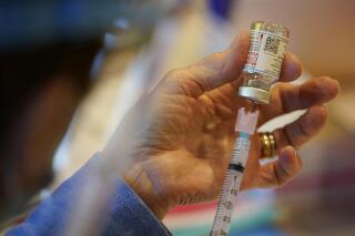 FILE - In this Dec. 29, 2020, file photo, Pat Moore, with the Chester County, Pa., Health Department, fills a syringe with Moderna COVID-19 vaccine before administering it to emergency medical workers and health care personnel at the Chester County Government Services Center in West Chester, Pa.   Moderna says its COVID-19 vaccine strongly protects kids as young as 12. The company released the preliminary findings Tuesday, May 25, 2021,  based on testing on more than 3,700 12- to 17-year-olds in the United States. (AP Photo/Matt Slocum, File)