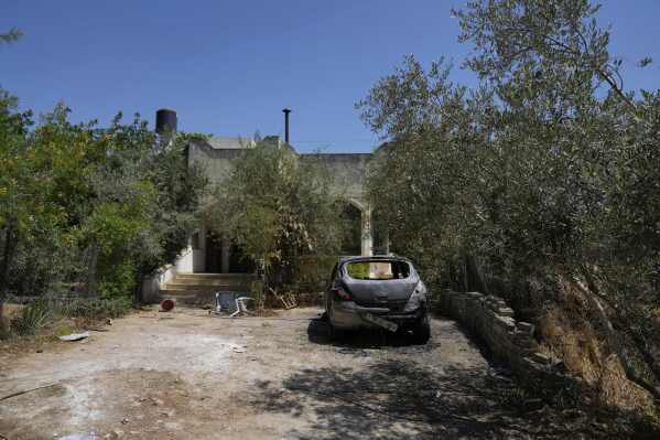 A Palestinian vehicle burnt during an overnight attack by Israeli settlers that left several burnt vehicles and damaged homes, residents said, in the West Bank village of Bruqin, near Salfit Friday, May 23, 2025. (AP Photo/Nasser Nasser)