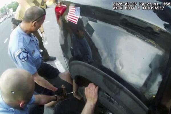 FILE - In this image from police body camera video shown as evidence in court, paramedics arrive as Minneapolis police officers, including Derick Chauvin, second from left, and J. Alexander Kueng restrain George Floyd in Minneapolis, on May 25, 2020. Former police Officers Tou Thao, Kueng and Thomas Lane are on trial in federal court accused of violating Floyd's civil rights as fellow Officer Derek Chauvin killed him. (Minneapolis Police Department via AP, File)
