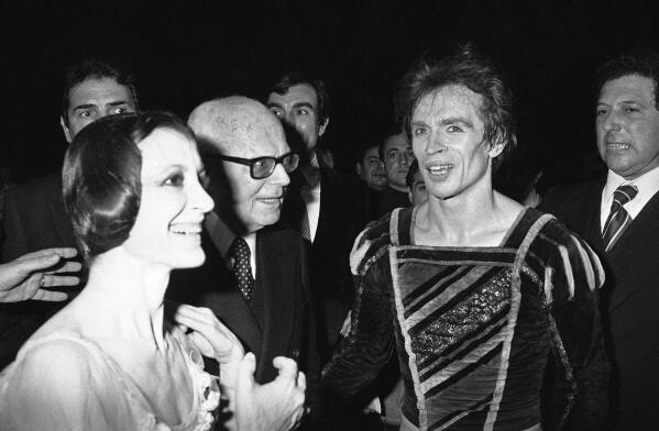 Italian ballet star Carla Fracci and Rudolf Nureyev are congratulated by Italian President Sandro Pertini after their performance in "Giselle" at the Rome Opera House, Feb. 7, 1980. Carla Fracci, an Italian cultural icon and former La Scala prima ballerina who formed a memorable partnership with Rudolf Nureyev, has died at her home in Milan. She was 84.  The La Scala theater announced her death Thursday with “great sadness,” without giving a cause. (AP Photo/Gianni Foggia)