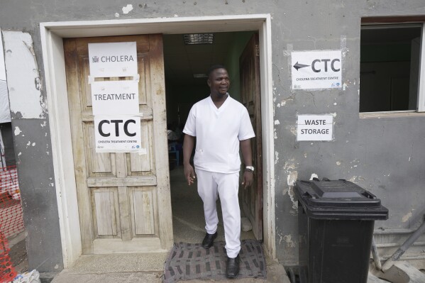 A nurse exits from a cholera treatment centre in Lusaka, Zambia, Saturday, March 9, 2024. (AP Photo/Tsvangirayi Mukwazhi)