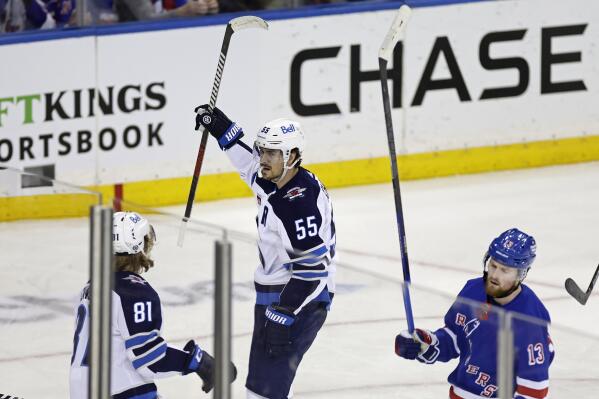 Winnipeg Jets center Mark Scheifele (55) reacts towards Kyle Connor (81) after scoring a goal in front of New York Rangers left wing Alexis Lafreniere (13) in the third period of an NHL hockey game Monday, Feb. 20, 2023, in New York. The Jets won 4-1. (AP Photo/Adam Hunger)
