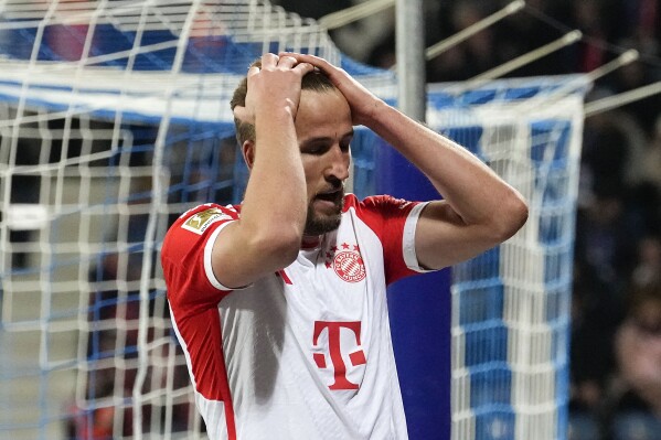 Bayern's Harry Kane reacts disappointed after missing a chance during the German Bundesliga soccer match between VfL Bochum and FC Bayern Munich in Bochum, Germany, Sunday, Feb. 18, 2024. (AP Photo/Martin Meissner)