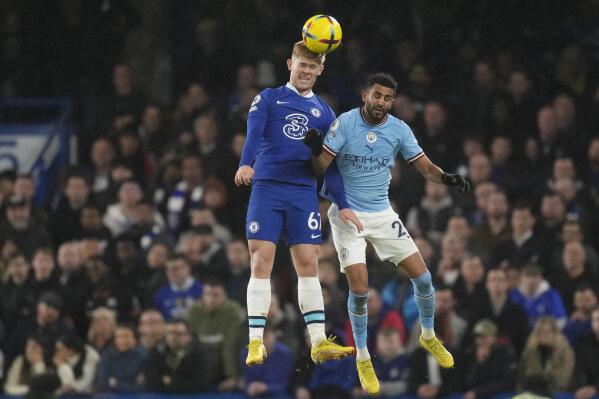 Chelsea's Lewis Hall, left, and Manchester City's Riyad Mahrez challenge for the ball during the English Premier League soccer match between Chelsea and Manchester City at Stamford Bridge stadium in London Thursday, Jan. 5, 2023. (AP Photo/Kirsty Wigglesworth)