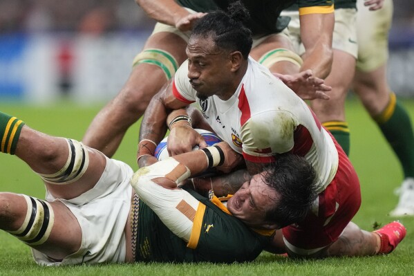 Tonga's Sonatane Takulua, top, fights for the ball with South Africa's Franco Mostert during the Rugby World Cup Pool B match between South Africa and Tonga, at Marseille's Stade Velodrome, France Sunday, Oct. 1, 2023. (AP Photo/Pavel Golovkin)
