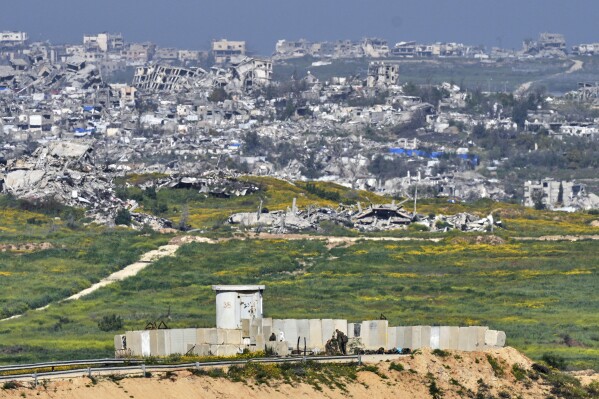 Israeli soldiers gather next to a military post on the border with Gaza Strip, in southern Israel, Tuesday, March 18, 2025. (AP Photo/Ohad Zwigenberg)