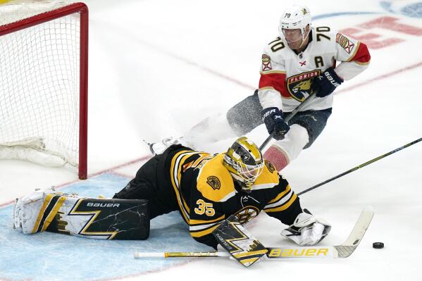 Boston Bruins goaltender Linus Ullmark (35) scrambles after the puck as Florida Panthers right wing Patric Hornqvist (70) looks for the rebound during the third period of an NHL hockey game, Tuesday, April 26, 2022, in Boston. (AP Photo/Charles Krupa)