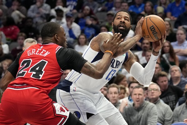 FILE - Chicago Bulls forward Javonte Green (24) defends as Dallas Mavericks forward Markieff Morris, right, works for a shot in the first half of an NBA basketball game Friday, April 7, 2023, in Dallas. Morris, the other piece of the trade that brought Kyrie Irving to Dallas from Brooklyn, is re-signing with the Mavericks. The return of Morris was announced Saturday, Sept. 16, 2023, a little more than two months after Irving agreed to stay with Dallas on a $120 million, three-year contract. Irving and Morris were traded in February. (AP Photo/Tony Gutierrez, File)