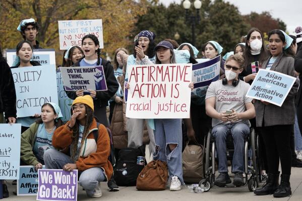 People rally outside the Supreme Court as the court begins to hear oral arguments in two cases that could decide the future of affirmative action in college admissions, Monday, Oct. 31, 2022, in Washington. (AP Photo/J. Scott Applewhite)