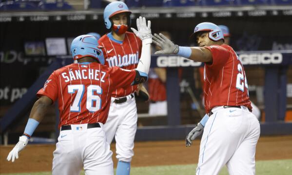 Miami Marlins' Jesus Sanchez, left, is congratulated by first base