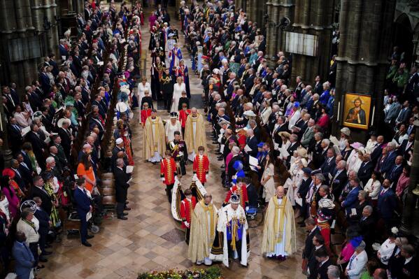 King Charles III, wearing the Imperial State Crown, followed by Queen Camilla, leaves Westminster Abbey in central London following his coronation ceremony, Saturday, May 6, 2023. (Ben Birchall/Pool via AP)