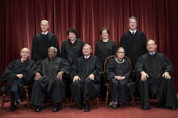FILE - In this Nov. 30, 2018, file photo, the justices of the U.S. Supreme Court gather for a formal group portrait to include a new Associate Justice, top row, far right, at the Supreme Court Building in Washington. Seated from left: Associate Justice Stephen Breyer, Associate Justice Clarence Thomas, Chief Justice of the United States John G. Roberts, Associate Justice Ruth Bader Ginsburg and Associate Justice Samuel Alito Jr. Standing behind from left: Associate Justice Neil Gorsuch, Associate Justice Sonia Sotomayor, Associate Justice Elena Kagan and Associate Justice Brett M. Kavanaugh. (ĢӰԺ Photo/J. Scott Applewhite, File)