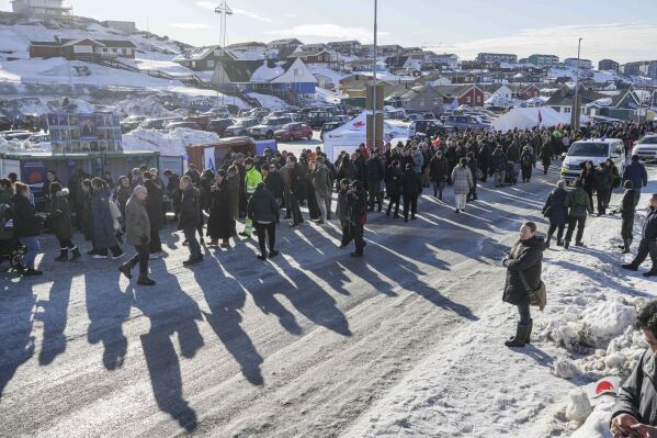 People stand in line outside a polling station to cast their vote in parliamentary elections, in Nuuk, Greenland, Tuesday, March 11, 2025. (AP Photo/Evgeniy Maloletka)