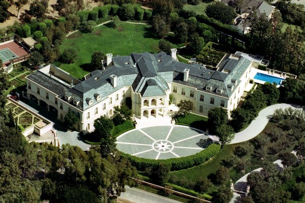 FILE - In this Sept. 1993, file photo, the home of Aaron Spelling is seen in the Holmby Hills section of Los Angeles. The gigantic Los Angeles mansion built for the late producer Aaron Spelling and his widow in 1991, has been sold for $119.75 million. The Los Angeles Times says the sale that closed Tuesday, July 2, 2019, is the highest home price in Los Angeles County history. After his death in 2006, his widow, Candy, sold the mansion for $85 million to Petra Ecclestone, daughter of Formula One billionaire Bernie Ecclestone. (AP Photo/Mark J. Terrill, File)