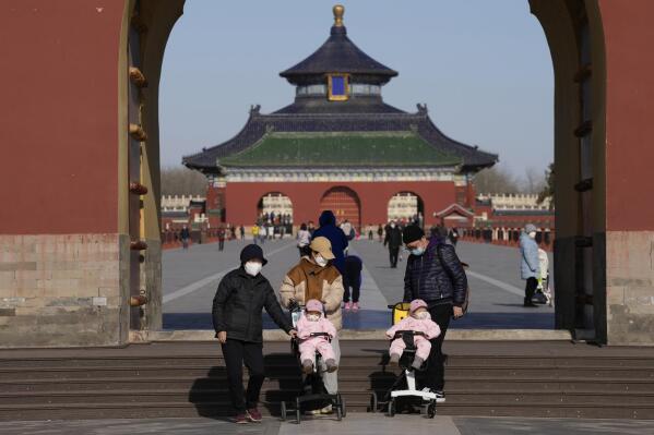 Visitors wear masks as they visit the Temple of Heaven park in Beijing, Thursday, Dec. 8, 2022. In a move that caught many by surprise, China announced a potentially major easing of its rigid "zero-COVID" restrictions, without formally abandoning the policy altogether. (AP Photo/Ng Han Guan)