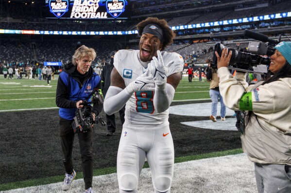 Miami Dolphins safety Jevon Holland (8) walks off the field after the team's win over the New York Jets during an NFL football game Friday, Nov. 24, 2023, in East Rutherford, N.J. (David Santiago/Miami Herald via AP)