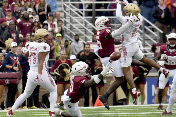A pass intended for Boston College wide receiver Lewis Bond (11) is caught by Florida State linebacker DJ Lundy (10) during the second half of an NCAA college football game, Saturday, Sept. 16, 2023 in Boston. (AP Photo/Mark Stockwell)