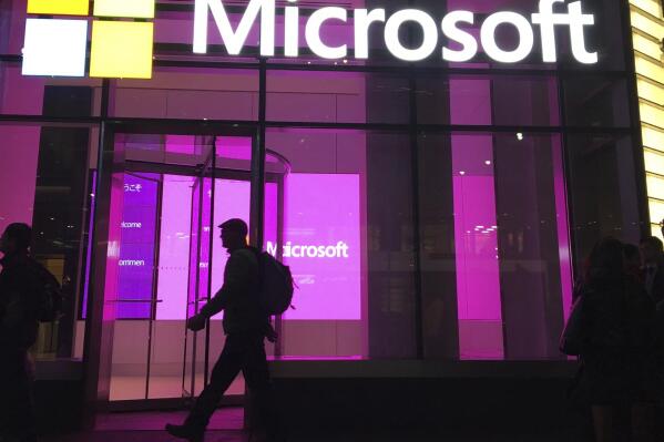 FILE - In this Nov. 10, 2016, file photo, people walk past a Microsoft office in New York. Microsoft on Oct. 7, 2021, says Russia once again accounted for most state-sponsored hacking, with a 58% share of intrusion attempts it detected in the past year. The targets were mostly government agencies — in the United States, followed by Ukraine, Britain and European NATO members. (AP Photo/Swayne B. Hall, File)