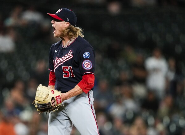Washington Nationals relief pitcher Jordan Weems reacts to striking out Seattle Mariners' Dylan Moore during the 11th inning of a baseball game to seal a 7-4 win, Tuesday, June 27, 2023, in Seattle. (AP Photo/Lindsey Wasson)