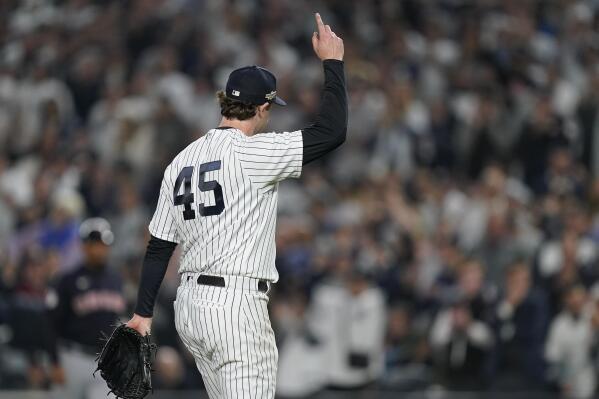 New York Yankees starting pitcher Gerrit Cole (45) motions to fans as he walks off the field during Game 1 of an American League Division baseball series against the Cleveland Guardians, Tuesday, Oct. 11, 2022, in New York. (AP Photo/John Minchillo)