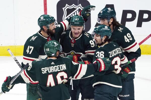 Minnesota Wild's Kirill Kaprizov (97) is swarmed by teammates congratulating him on his goal off Dallas Stars goalie Anton Khudobin in the first period of an NHL hockey game, Thursday, Nov. 18, 2021, in St. Paul, Minn. (AP Photo/Jim Mone)